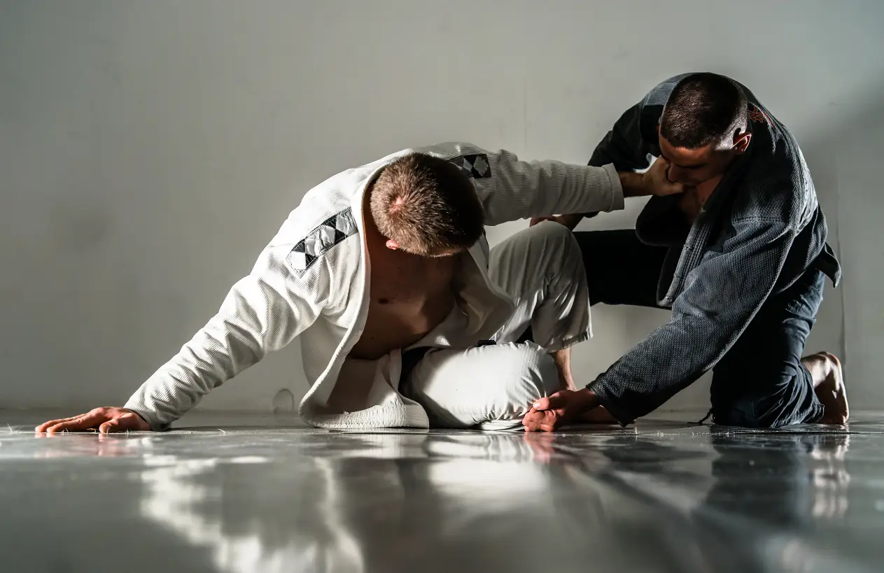 Two Sentry Jiu-Jitsu students in a dramatic studio-lit Brazilian Jiu-Jitsu exchange