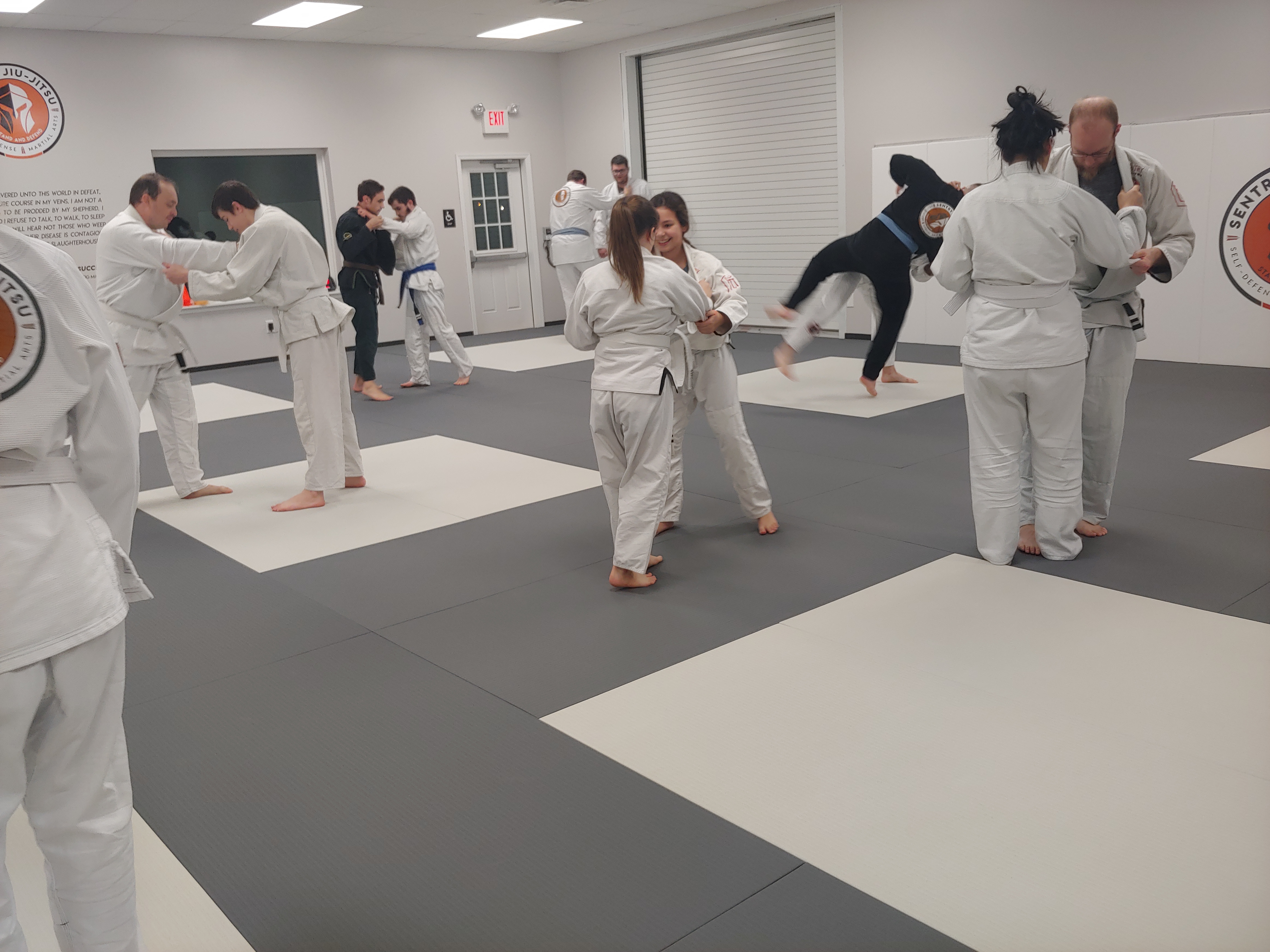 A full adult Brazilian Jiu-Jitsu class drilling self-defense technique on the mats at Sentry Jiu-Jitsu